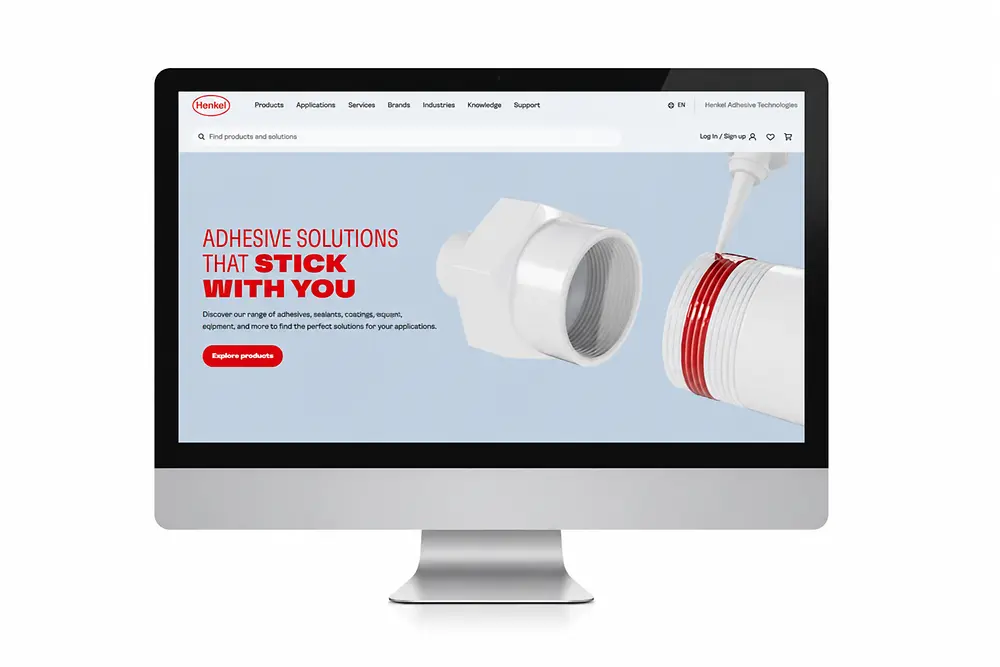 Ekran monitora ze stroną internetową Henkel Adhesive Technologies.