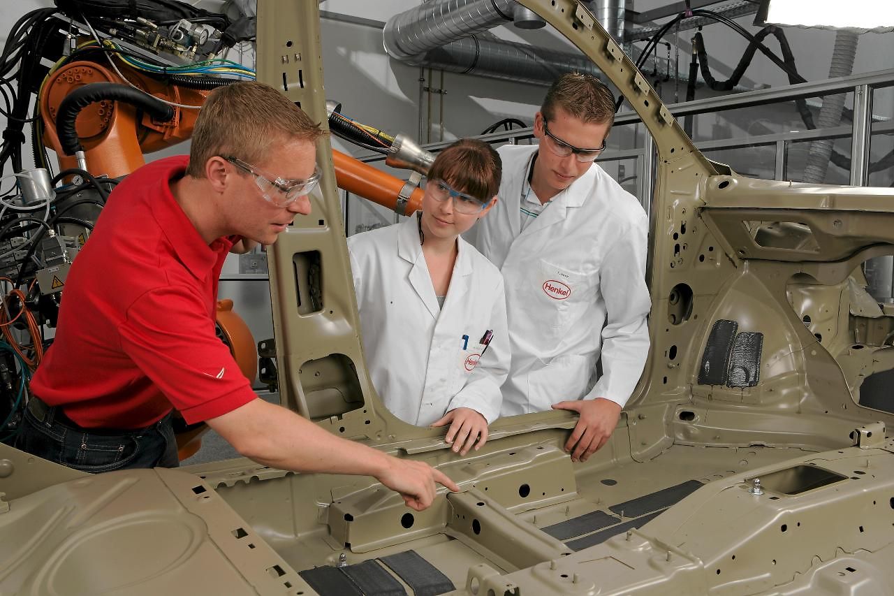 Henkel employees working on lightweight automotive components.