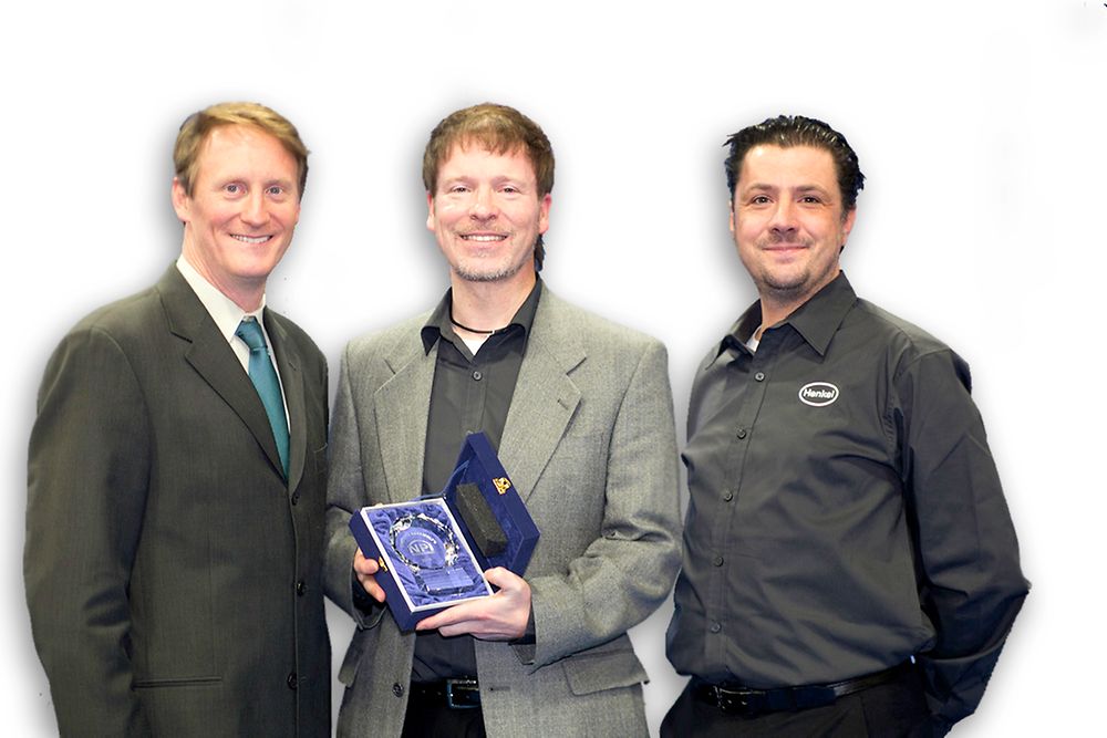 Henkel’s Dr. Mark Currie (center) and Ian Wilding (right) accept Loctite GC 10’s NPI Award