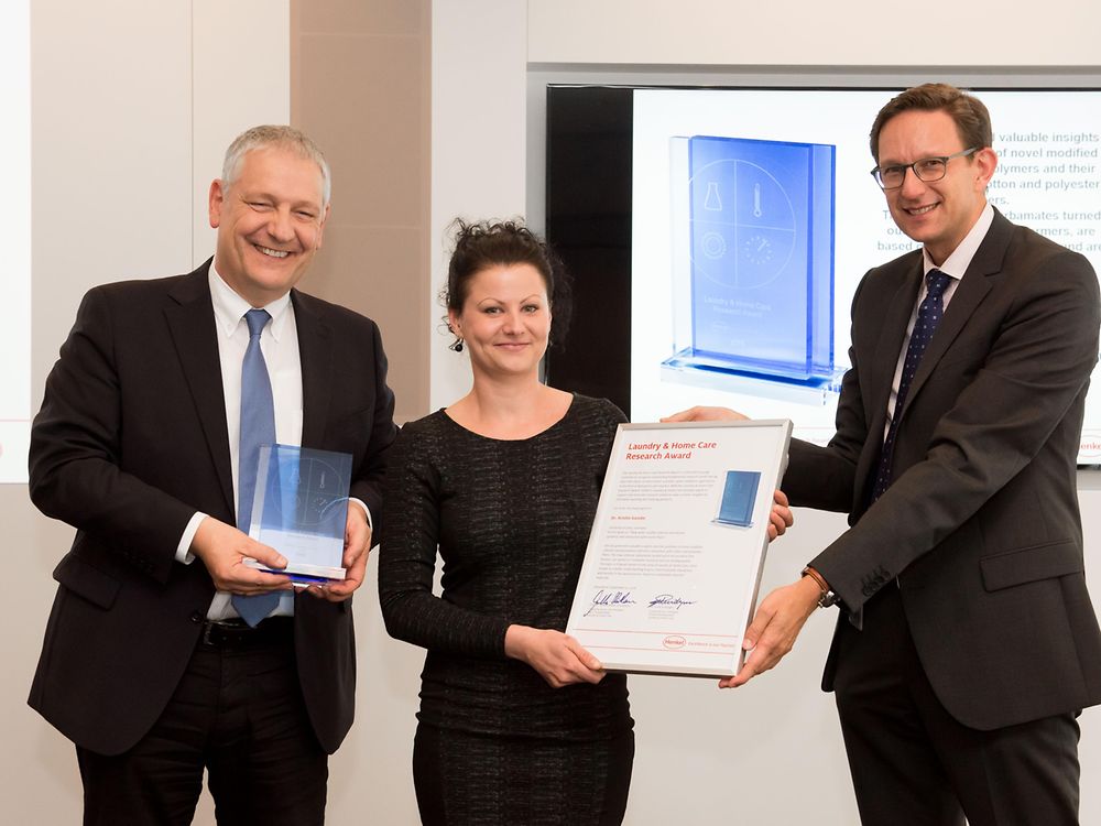 Prof. Dr. Thomas Müller-Kirschbaum (left) and Dr. Michael Dreja present the Laundry & Home Care Research Award 2016 to Dr. Kristin Ganske